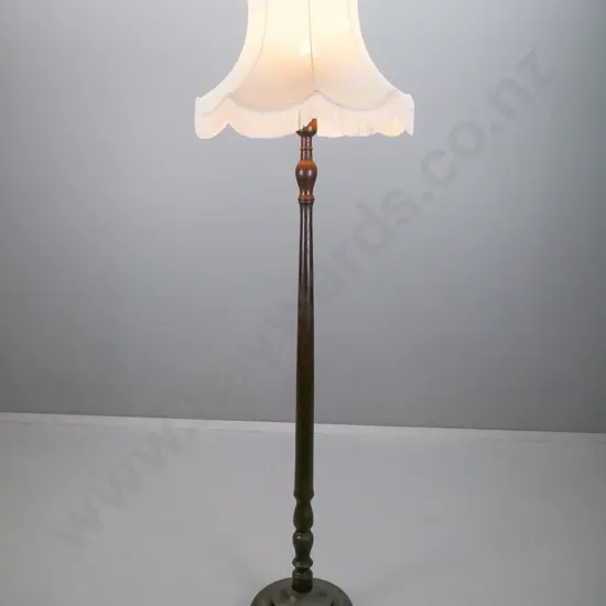 vintage oak standard lamp with turned column, stepped circular base on turned feet, fringed waisted shade. Some staining