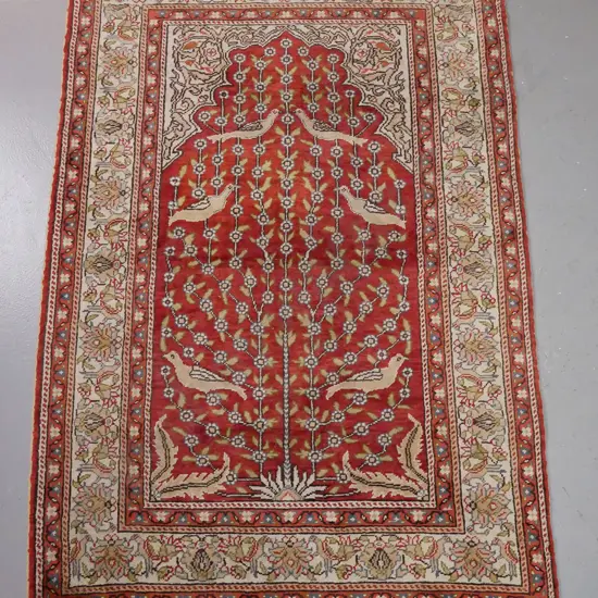 Persian style wool floor rug or large prayer rug with arched bird and lotus panel - orange-red and beige-brown tones -