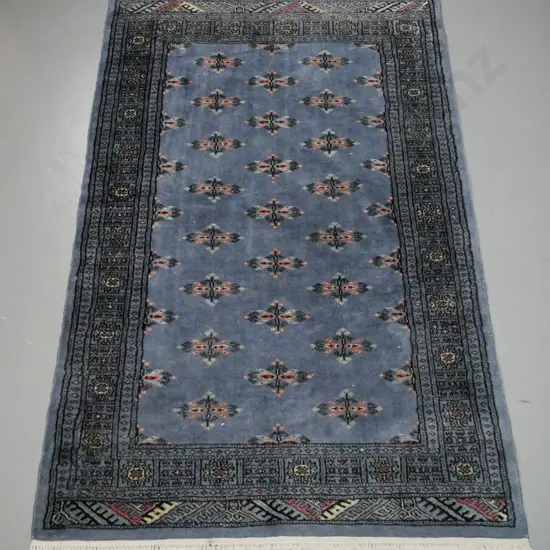 hand-knotted wool Persian style floor rug - blue with red, black & ivory tones. Wear to edges and to border at one end