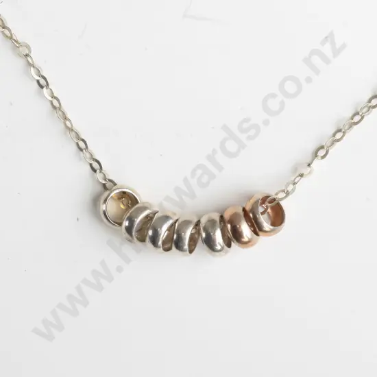 silver necklace with 7 small rings