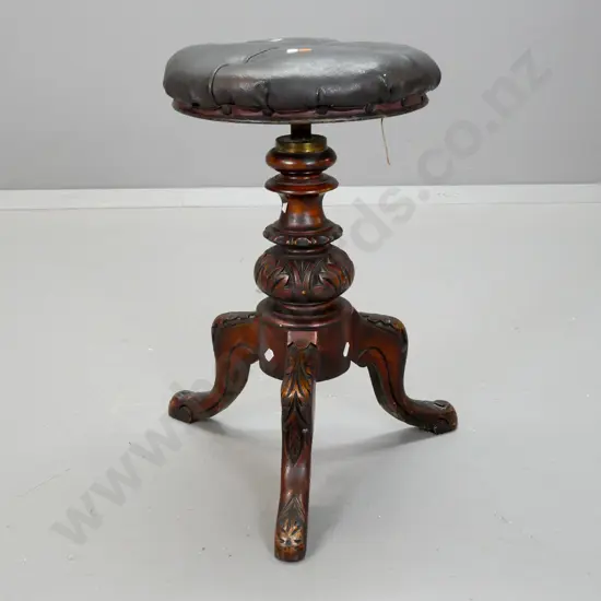 Victorian revolving piano stool with buttoned buckram top, carved pedestal base on 3 sweeping legs, height adjustment