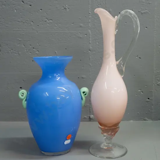 2 pieces of art glass - blue vase with green scroll handles and a pink over white jug with twisted handle and stem H-350