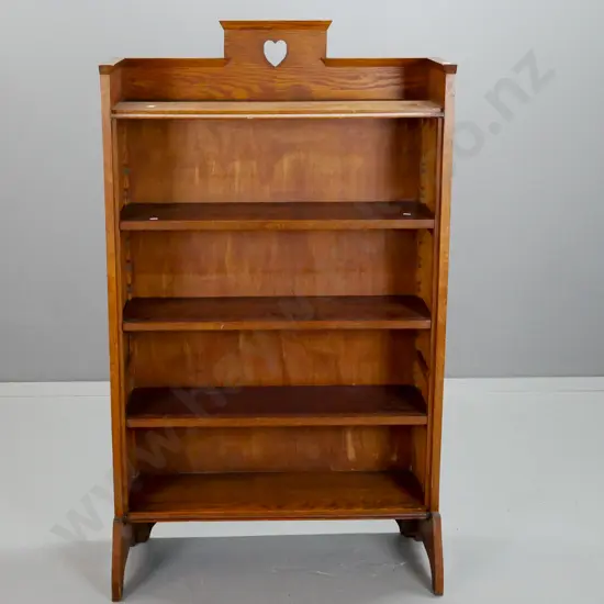 oak arts & crafts style bookcase with 3 adjustable shelves, pierced heart motif cutout at top - some fading to one side