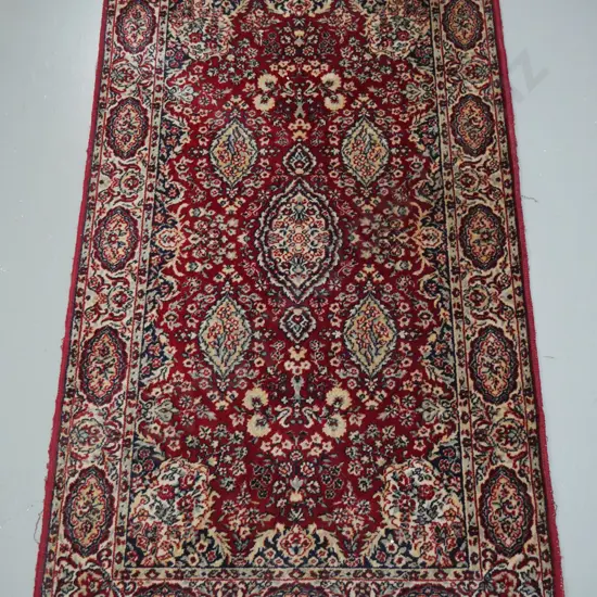 wool Persian style floor rug in red, ivory and blue. Wear to edges and fringe worn off one end L-1590 W-910