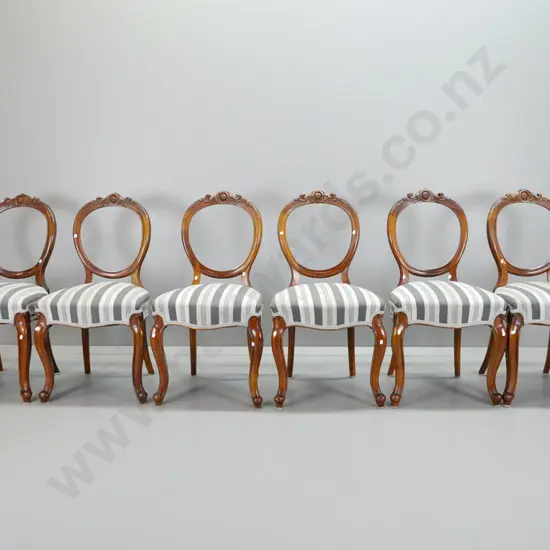 set of 6 Victorian walnut cab-leg balloon back dining chairs with carved crest on back, striped fabric upholstered seat.