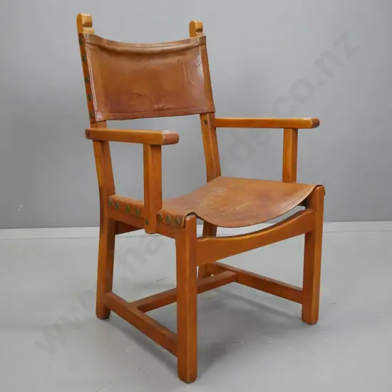 vintage leather slung mahogany fireside chair with large brass studding, back has tooled letter "P" - minor staining and