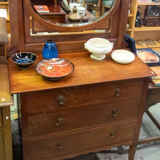 vintage oak mirror-back dresser with oval bevelled-edge mirror, press-carved panel, 3 drawers with drop handles, on