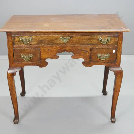 late Georgian oak low-boy with 3 drawers, shaped knee hole, on turned & tapered legs w pad feet, brass handles and