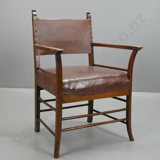 vintage beech open-arm fireside chair on turned stretcher base, studded leather upholstered seat and replaced back. Some