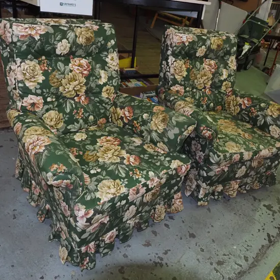 pair of green floral armchairs