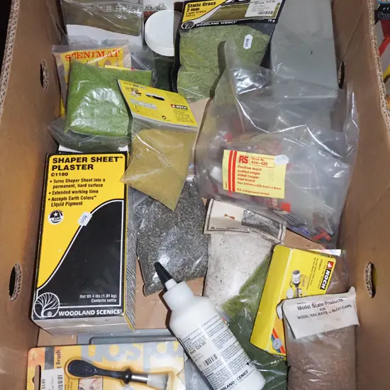box of train layout materials; grasses, gravel etc