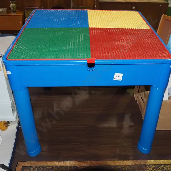 plastic child's table with Lego boards and internal storage