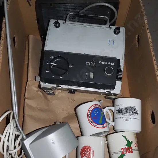 box; halogen desk lamp, coffee cups, Super 8 movie projector 