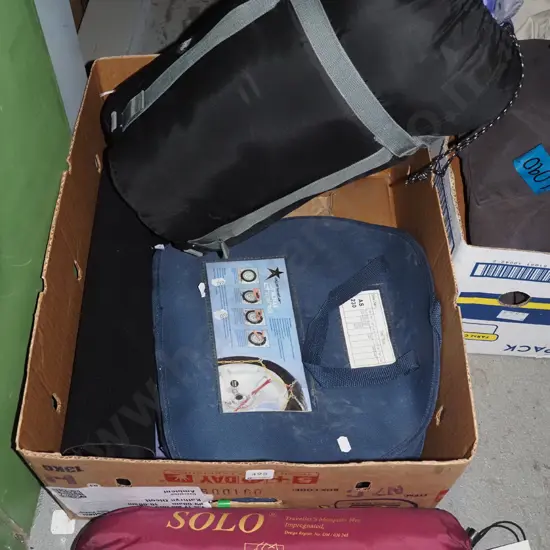 box; snow chains, mosquito net, portable dart boards, sleeping bag