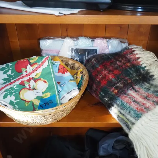 cane basket, tea towels, small mohair rug