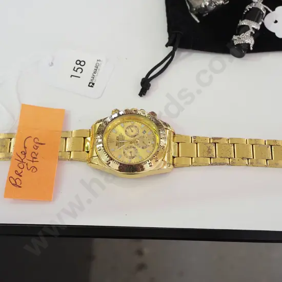 gents wristwatch with broken strap