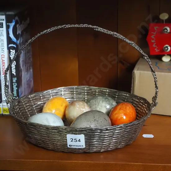 woven wire basket, ornamental stone eggs
