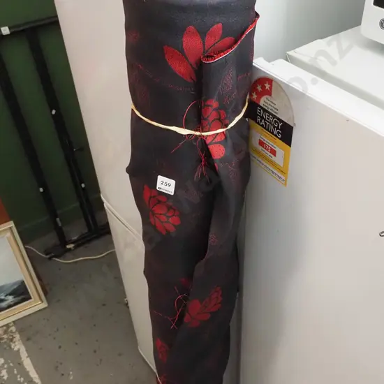 roll of black and red floral fabric