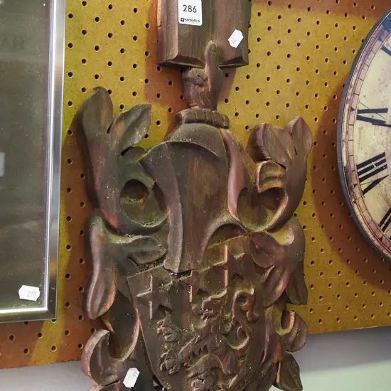 carved wooden coat of arms