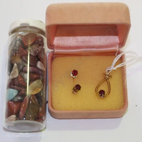 small container of polished stones, pendant etc