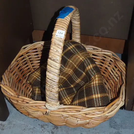 large cane basket, piece of woollen tartan fabric