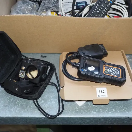 cased KB X3 action camera and a CY3001 fault diagnosis instrument with box