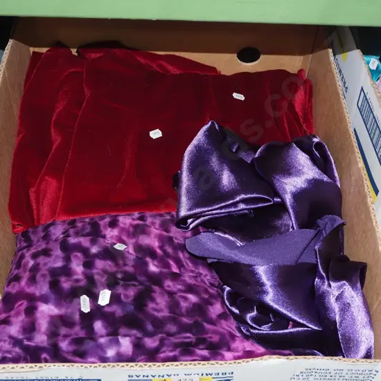 box; red and purple fabric pieces