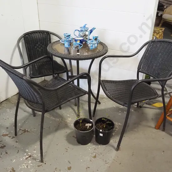 woven plastic and glass top patio table and 3 chairs
