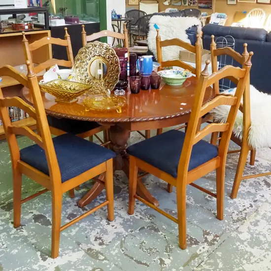 mahogany veneer circular pedestal drop side table with 6 upholstered ladder back chairs 