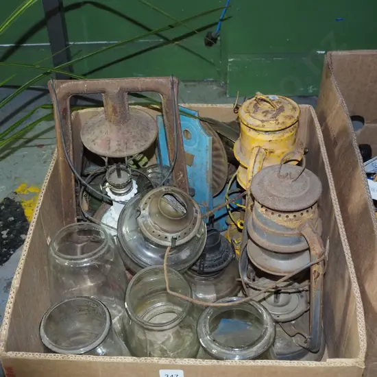 box of restorer's hurricane lanterns and lantern parts