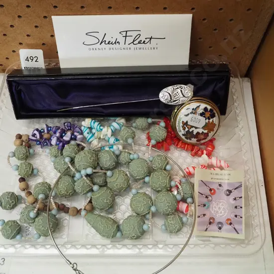 tray of necklaces, bookmark etc