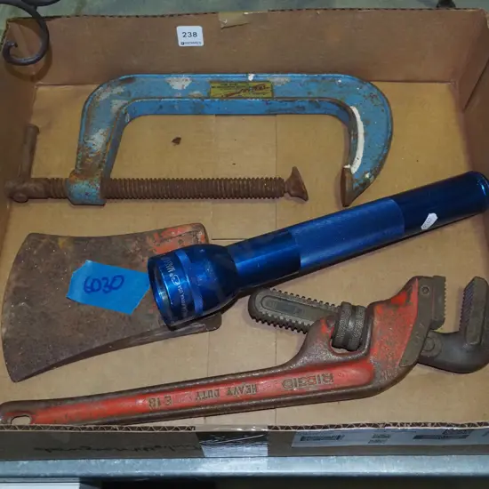 box; plumbers stilsons, large axe head, G clamp, mag light torch