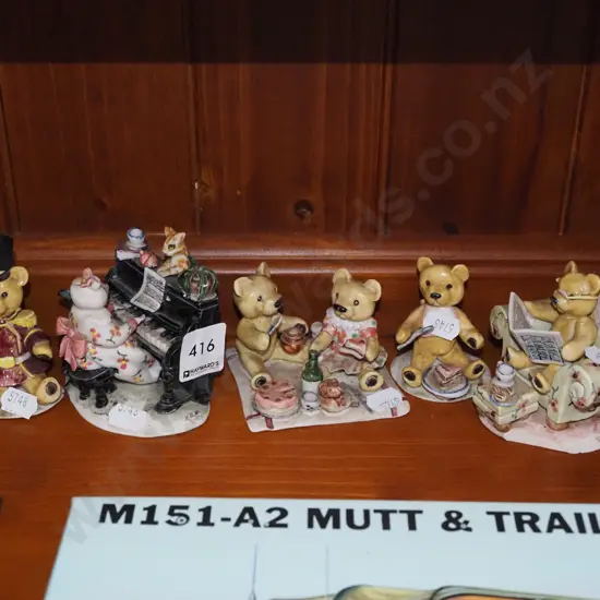 shelf of teddy bear figurines, piano playing mouse