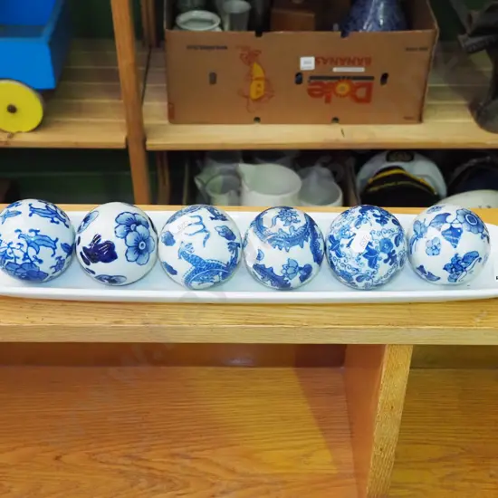 white elongated ceramic dish, 6x ornamental balls