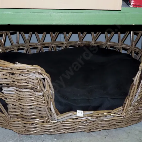 large cane and upholstered dog basket