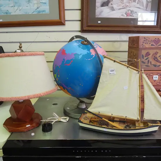 hand painted world globe, small wood based desk lamp, model yacht