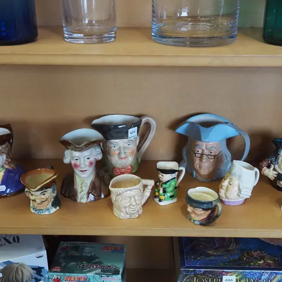 shelf; toby jugs - some have chips and cracks