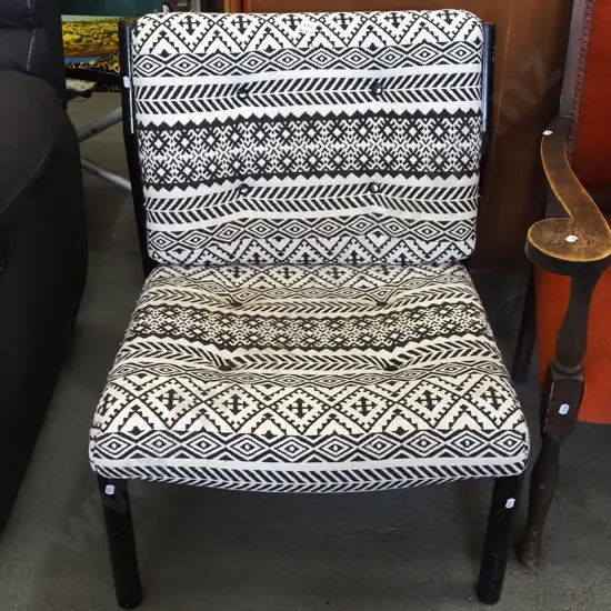 metal and black and white upholstered deep buttoned chair