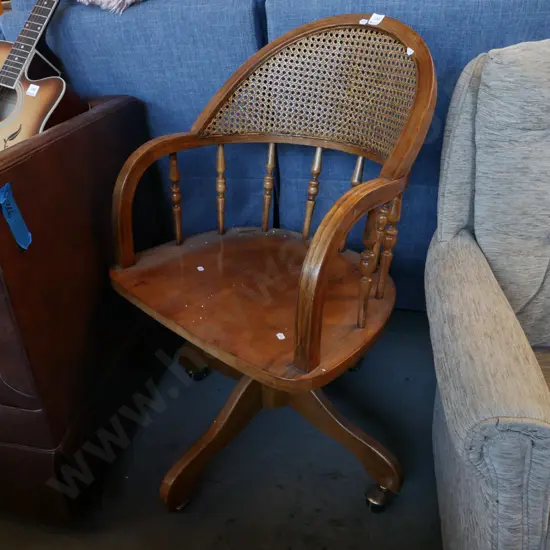 oak spindle back and rattan captain's chair on casters
