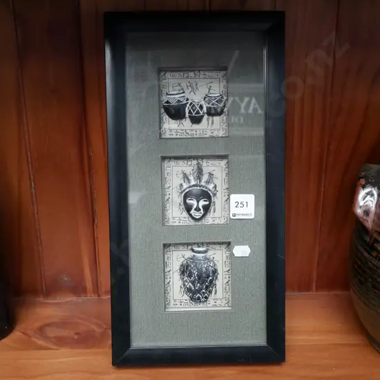 framed ethnic themed faces and pots