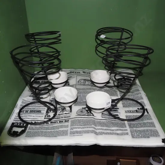 black metal and paper hot chip stand with small ceramic sauce bowls