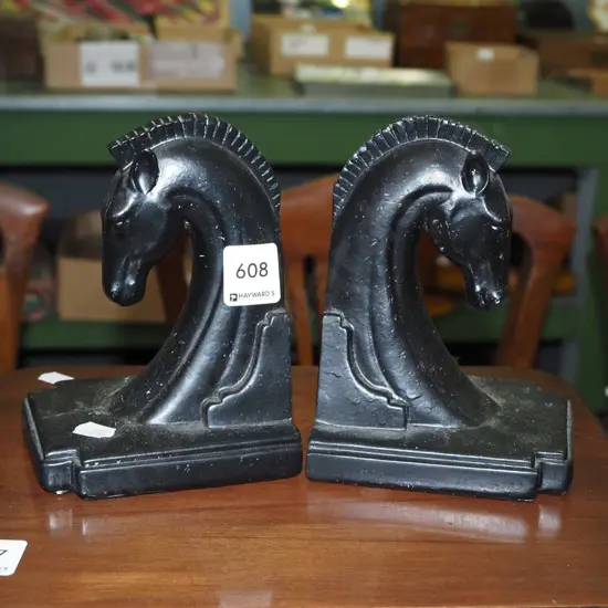 pair of ebonised wood, classical horse themed book ends