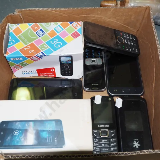 box of early cell phones and accessories