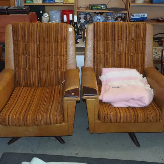 pair of retro deep buttoned fabric and vinyl upholstered swivel rocking chairs