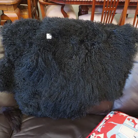 2x black woollen sheepskins