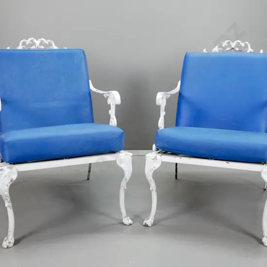 pair of cast alloy white painted patio lounge chairs with blue vinyl squabs - aging and discolouration to vinyl, arms