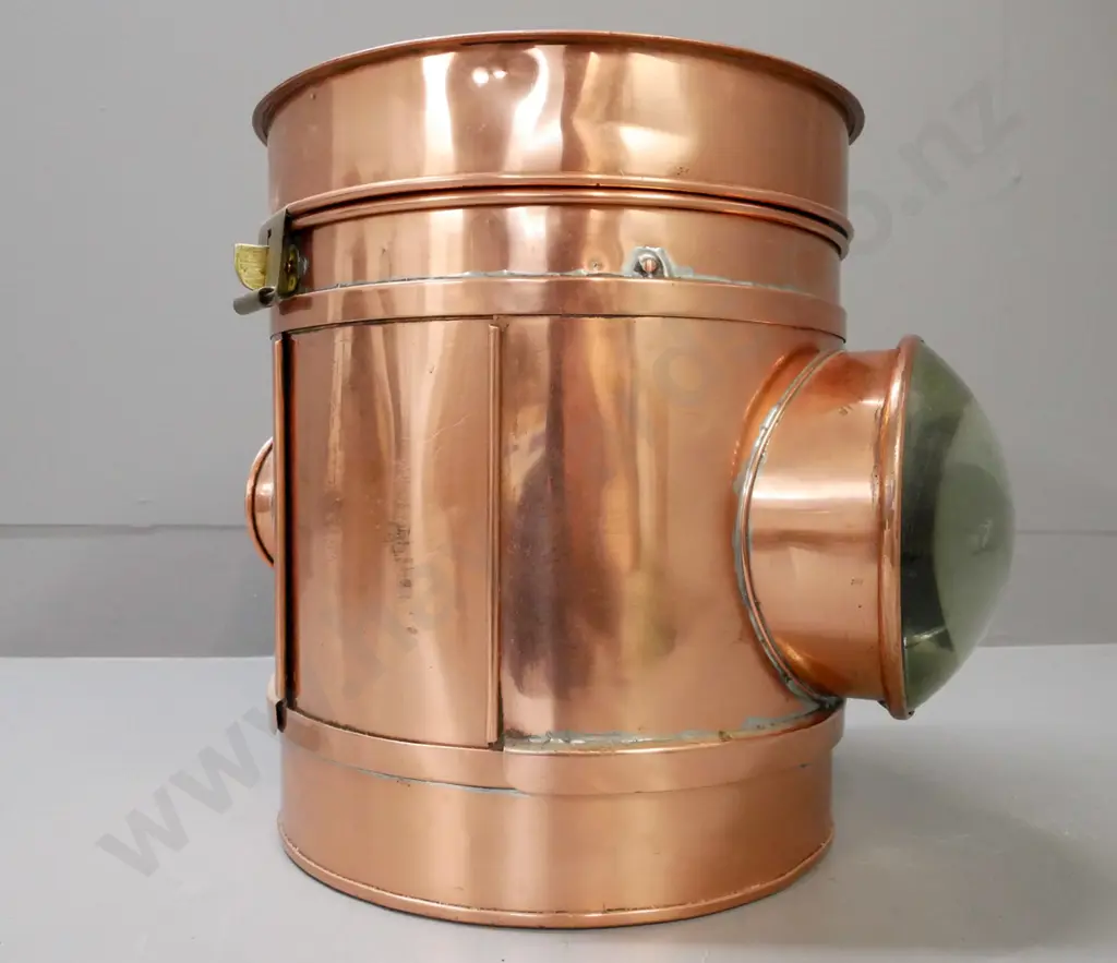 circular copper vintage lantern. Magnifying domed lens on one side, small lens opposite. Brass clasp. Image 1++
