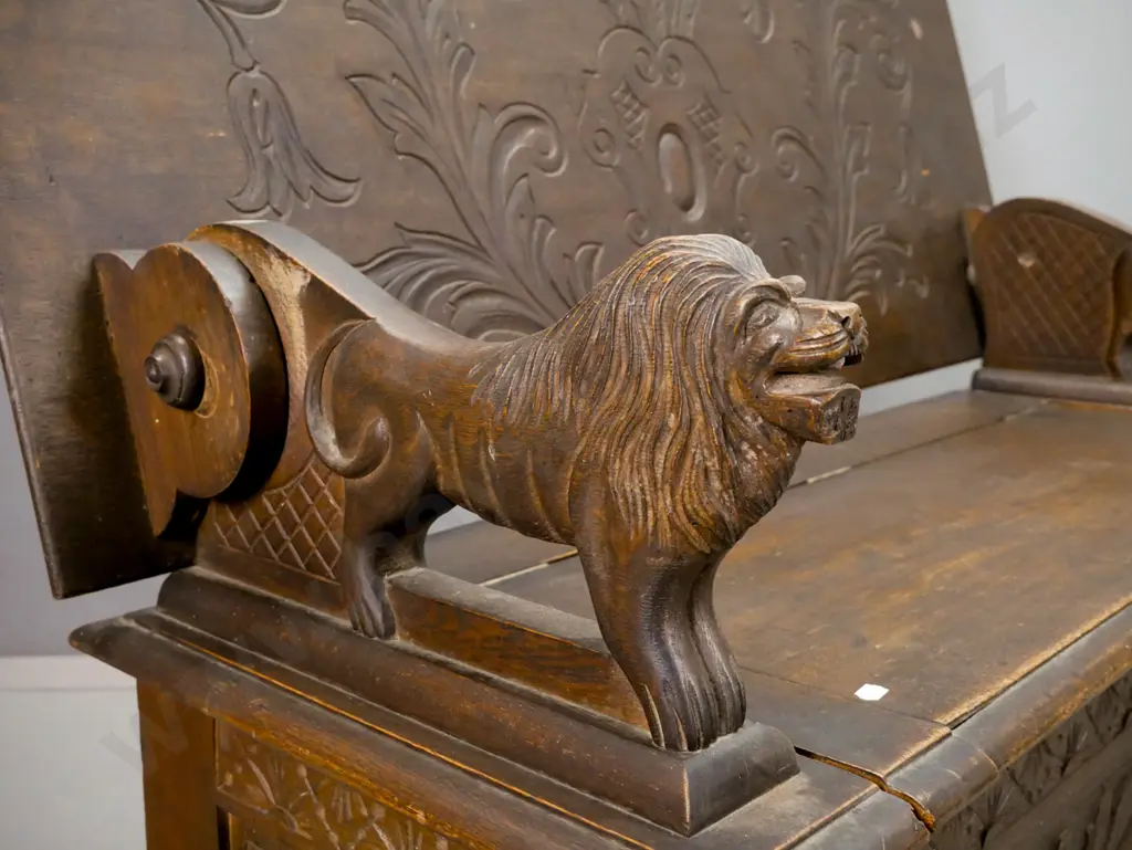 vintage Jacobean style oak monk's seat with carved foliate carved top & base panels, lion arm rests, seat back has Image 1++