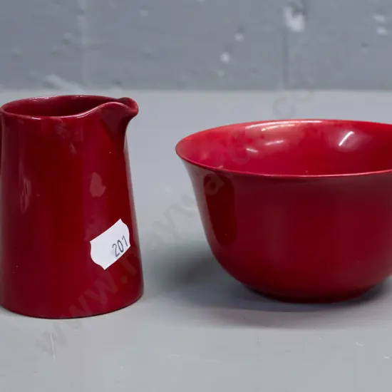 2 small pieces of Royal Doulton Flambe with plain text mark. Bowl has mottled yellow inside. Glaze wear to base of