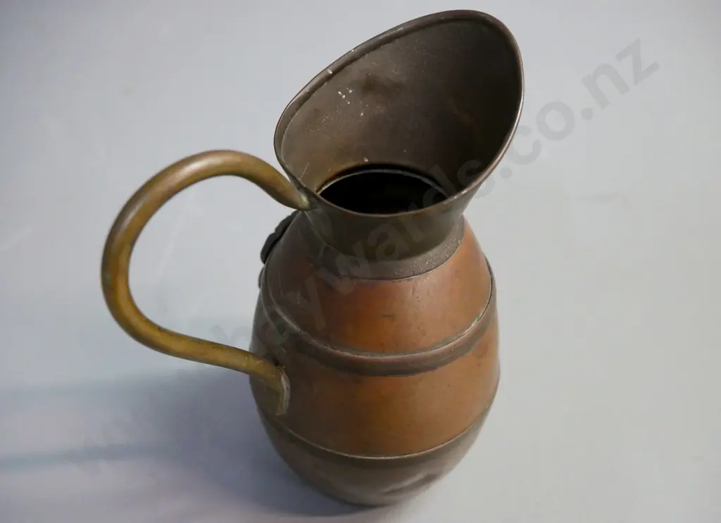 brass and copper jug with 'NZ Tiki' and applied brass Tiki, some dents. H-130, D-100 Image 1++